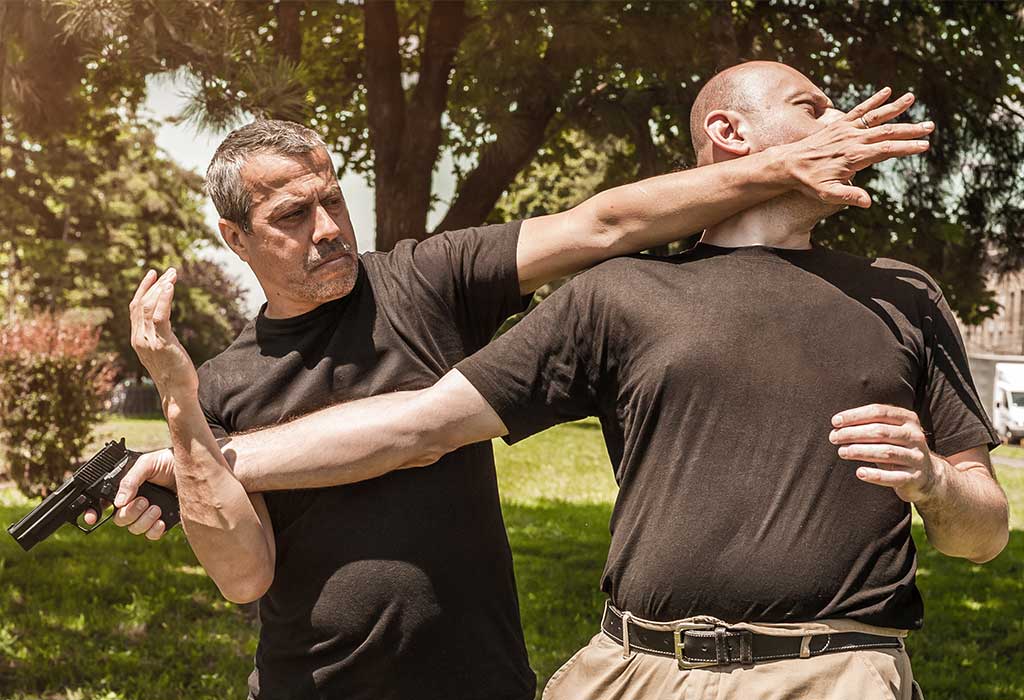 Kapap instructor demonstrates self defense techniques against a gun