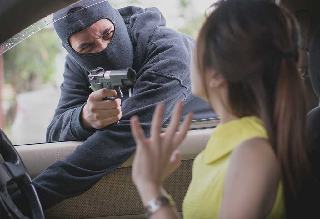Thief pointing gun to victim and hijacking car